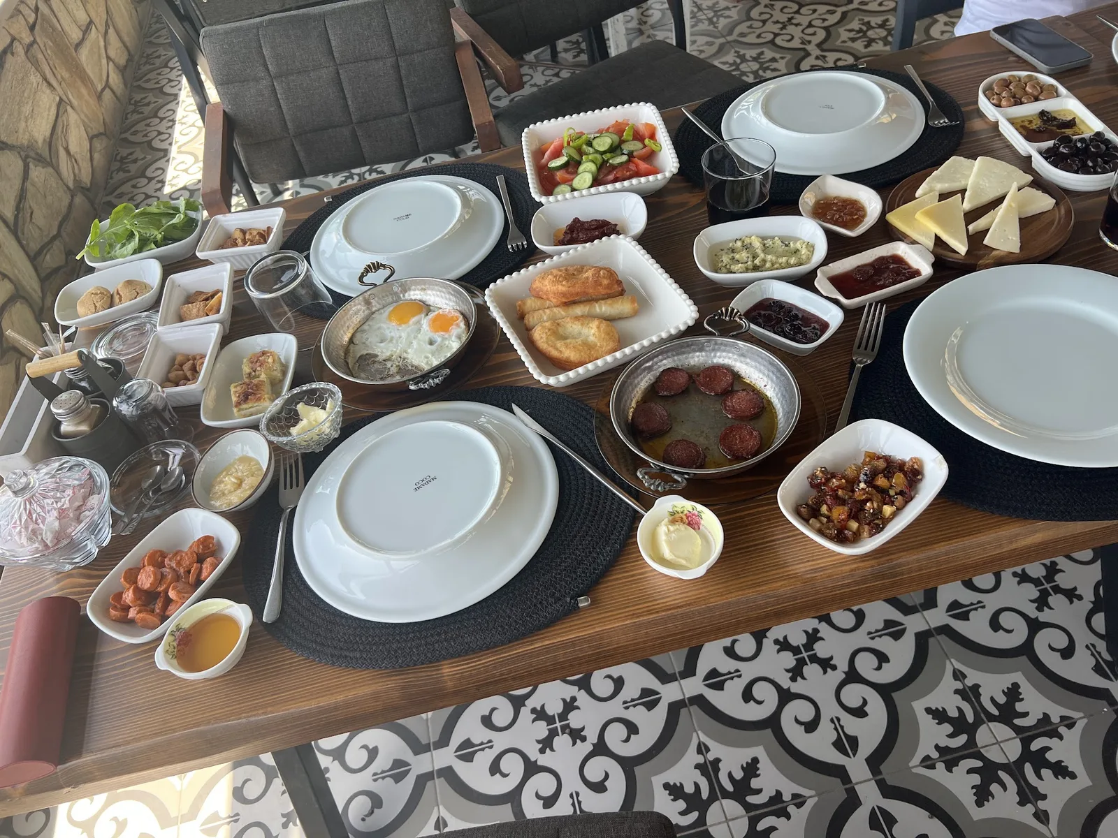 A breakfast table on the patterned-tile terrace